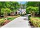 Picturesque home with long driveway, beautiful landscaping, and vibrant green trees at 2201 Avinshire Pl, Wake Forest, NC 27587