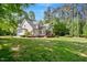 Beautiful exterior of the home showcasing the backyard and lush landscaping at 2201 Avinshire Pl, Wake Forest, NC 27587