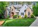 Elegant two-story home boasting stone accents, manicured lawn, and inviting curb appeal at 2201 Avinshire Pl, Wake Forest, NC 27587