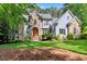 Stunning two-story home with stone and siding exterior and lush green lawn at 2201 Avinshire Pl, Wake Forest, NC 27587