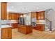 Gourmet kitchen boasts cherry cabinets, a center island, stainless steel appliances, and hardwood floors at 2201 Avinshire Pl, Wake Forest, NC 27587