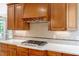 Gourmet kitchen features white countertops, stainless steel appliances, and cherry cabinets at 2201 Avinshire Pl, Wake Forest, NC 27587