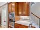 Gourmet kitchen boasts cherry cabinets, stainless steel appliances, and hardwood floors at 2201 Avinshire Pl, Wake Forest, NC 27587