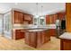 Gourmet kitchen boasts cherry cabinets, a center island, stainless steel appliances, and hardwood floors at 2201 Avinshire Pl, Wake Forest, NC 27587