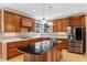 Gourmet kitchen boasts cherry cabinets, a center island, stainless steel appliances, and hardwood floors at 2201 Avinshire Pl, Wake Forest, NC 27587