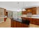 Gourmet kitchen boasts cherry cabinets, a center island, stainless steel appliances, and hardwood floors at 2201 Avinshire Pl, Wake Forest, NC 27587