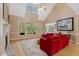 Bright living room with high ceilings, large windows, fireplace, and red sofas for comfortable gathering at 2201 Avinshire Pl, Wake Forest, NC 27587
