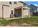 View of a two-story home with a spacious backyard and a covered patio area perfect for outdoor entertaining at 244 N Prince Henry Way, Cameron, NC 28326