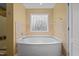 Bathroom featuring a soaking tub, decorative glass window, and neutral paint at 244 N Prince Henry Way, Cameron, NC 28326