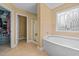 Bathroom featuring a soaking tub, shower, decorative glass window, and walk-in closet at 244 N Prince Henry Way, Cameron, NC 28326