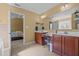 Bathroom featuring double sinks, vanities and mirror; adjoining bedroom at 244 N Prince Henry Way, Cameron, NC 28326