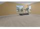 Spacious carpeted bonus room featuring a treadmill and natural light at 244 N Prince Henry Way, Cameron, NC 28326