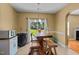 Cozy dining area with modern bar and access to the well-manicured backyard and a glimpse of the fireplace in the next room at 244 N Prince Henry Way, Cameron, NC 28326