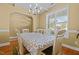Light-filled dining room featuring hardwood floors and a modern chandelier at 244 N Prince Henry Way, Cameron, NC 28326
