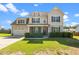 Charming two-story home featuring a manicured lawn and an inviting covered porch at 244 N Prince Henry Way, Cameron, NC 28326