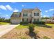 Charming two-story home featuring a manicured lawn and an inviting covered porch at 244 N Prince Henry Way, Cameron, NC 28326