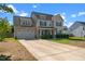 Beautiful two-story home featuring a lush lawn and an inviting covered porch at 244 N Prince Henry Way, Cameron, NC 28326