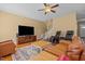 Cozy living room with comfortable seating, large screen television, and staircase leading upstairs at 244 N Prince Henry Way, Cameron, NC 28326