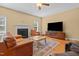 Comfortable living room with fireplace, ceiling fan, and a large television for entertaining friends and Gathering at 244 N Prince Henry Way, Cameron, NC 28326