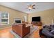 Comfortable living room with fireplace, ceiling fan, and natural light enhancing the living space for relaxation at 244 N Prince Henry Way, Cameron, NC 28326
