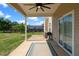 Covered patio featuring a ceiling fan, a grilling area with a propane grill, and a sliding glass door entrance at 244 N Prince Henry Way, Cameron, NC 28326
