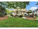 Expansive backyard with patios, seating areas, and beautifully landscaped greenery at 2637 Forestbluff Dr, Fuquay Varina, NC 27526