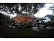 Large backyard featuring a patio with firepit seating area, grassy area, and beautiful evening landscaping with market lights at 2637 Forestbluff Dr, Fuquay Varina, NC 27526