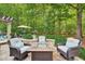 Beautiful backyard patio with fire pit, seating, and lush green surroundings at 2637 Forestbluff Dr, Fuquay Varina, NC 27526