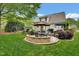 Well-manicured backyard with patio areas, lush greenery, and mature trees at 2637 Forestbluff Dr, Fuquay Varina, NC 27526
