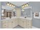 Bathroom with double vanity, cabinetry, and large mirrors at 2637 Forestbluff Dr, Fuquay Varina, NC 27526