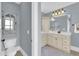 Bathroom with toilet, vanity, drawers, and large mirror at 2637 Forestbluff Dr, Fuquay Varina, NC 27526