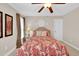 Cozy bedroom with ceiling fan, window, neutral walls, and a large bed with decorative pillows and comforter at 2637 Forestbluff Dr, Fuquay Varina, NC 27526