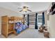 Spacious bedroom features a bunk bed with a ceiling fan, curtains, and framed pictures at 2637 Forestbluff Dr, Fuquay Varina, NC 27526