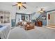 Open bonus room with seating, a built-in window seat, shelving, and a bar area, perfect for entertaining at 2637 Forestbluff Dr, Fuquay Varina, NC 27526
