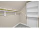 Walk-in closet with a hanging rod, shelves, and door, offering ample storage space at 2637 Forestbluff Dr, Fuquay Varina, NC 27526
