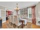 Elegant dining room with a chandelier, hardwood floors, and large windows at 2637 Forestbluff Dr, Fuquay Varina, NC 27526