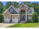Beautiful two-story brick home featuring a three-car garage and well-maintained landscaping at 2637 Forestbluff Dr, Fuquay Varina, NC 27526