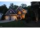 Beautiful brick home featuring manicured landscaping, arched entryway, and a two-car garage at 2637 Forestbluff Dr, Fuquay Varina, NC 27526