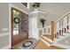 Bright foyer featuring hardwood floors, staircase, and double doors with transom windows at 2637 Forestbluff Dr, Fuquay Varina, NC 27526