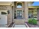 Inviting front porch with double doors, brick entryway, rocking chair, and cozy decor at 2637 Forestbluff Dr, Fuquay Varina, NC 27526