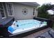 Outdoor hot tub with a wooden deck surround for relaxation at 2637 Forestbluff Dr, Fuquay Varina, NC 27526