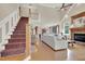 Spacious living room with a cozy fireplace, staircase, and an open-concept design at 2637 Forestbluff Dr, Fuquay Varina, NC 27526