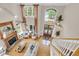 Open-concept living room boasting hardwood floors, fireplace, and an abundance of natural light at 2637 Forestbluff Dr, Fuquay Varina, NC 27526