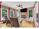 Cozy living room with a stone fireplace, large windows, and comfortable seating at 2637 Forestbluff Dr, Fuquay Varina, NC 27526
