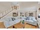 Inviting living room featuring a sectional sofa, wood floors, and an open floor plan at 2637 Forestbluff Dr, Fuquay Varina, NC 27526