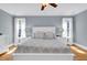 Bright main bedroom boasts neutral walls, hardwood floors, and a ceiling fan at 2637 Forestbluff Dr, Fuquay Varina, NC 27526
