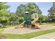 Community playground featuring slides and play equipment, surrounded by lush greenery at 2637 Forestbluff Dr, Fuquay Varina, NC 27526