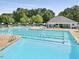Community pool with ample seating and umbrellas for residents to enjoy at 2637 Forestbluff Dr, Fuquay Varina, NC 27526