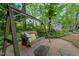 Backyard featuring a charming wooden swing with pillows, a pea gravel base and a shed, a perfect spot for relaxation at 2908 Bolo Trl, Raleigh, NC 27615