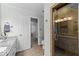 Bathroom with tiled floor, granite counter tops, white cabinets and a glass enclosed shower at 2908 Bolo Trl, Raleigh, NC 27615